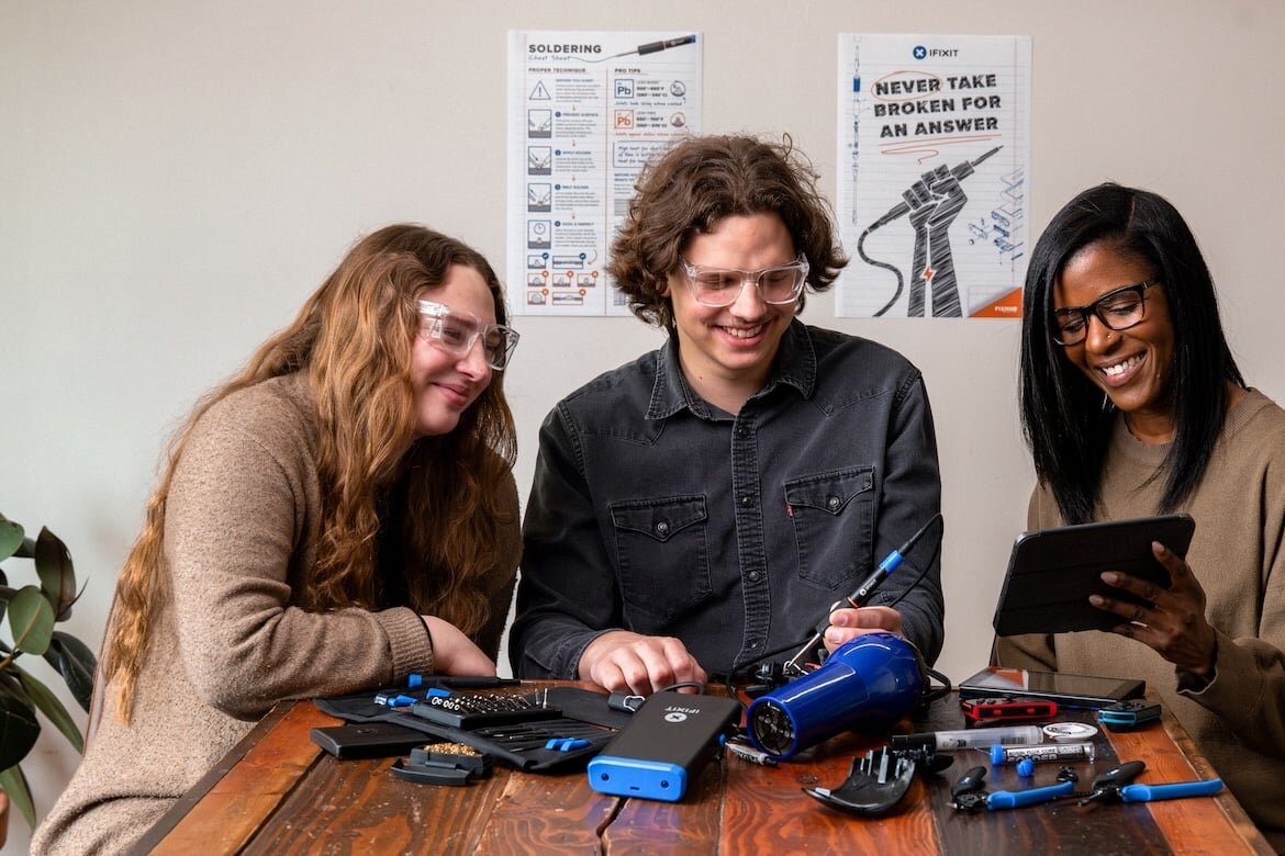 Two people repairing electronics together