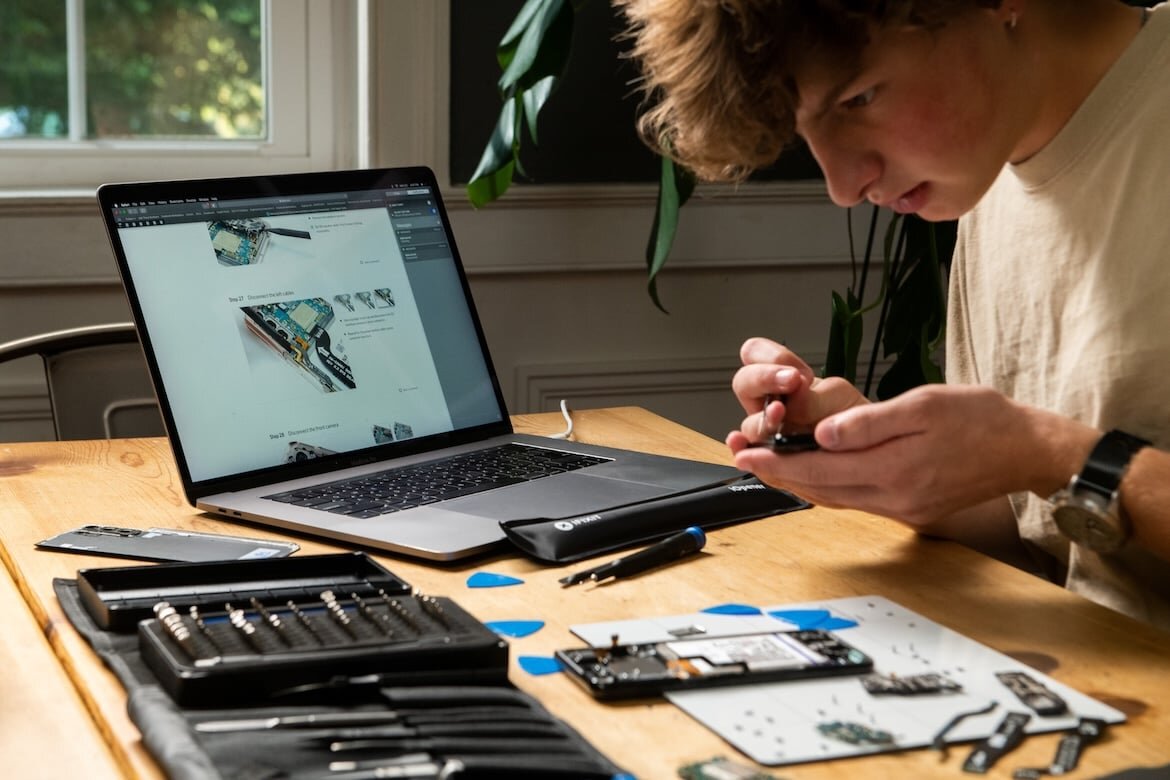 A person repairing a laptop